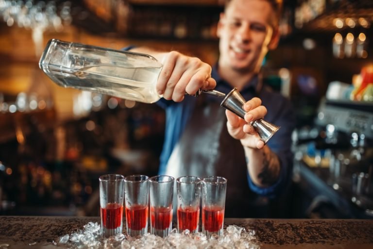 male-barman-in-apron-prepares-alcoholic-coctail-768x513